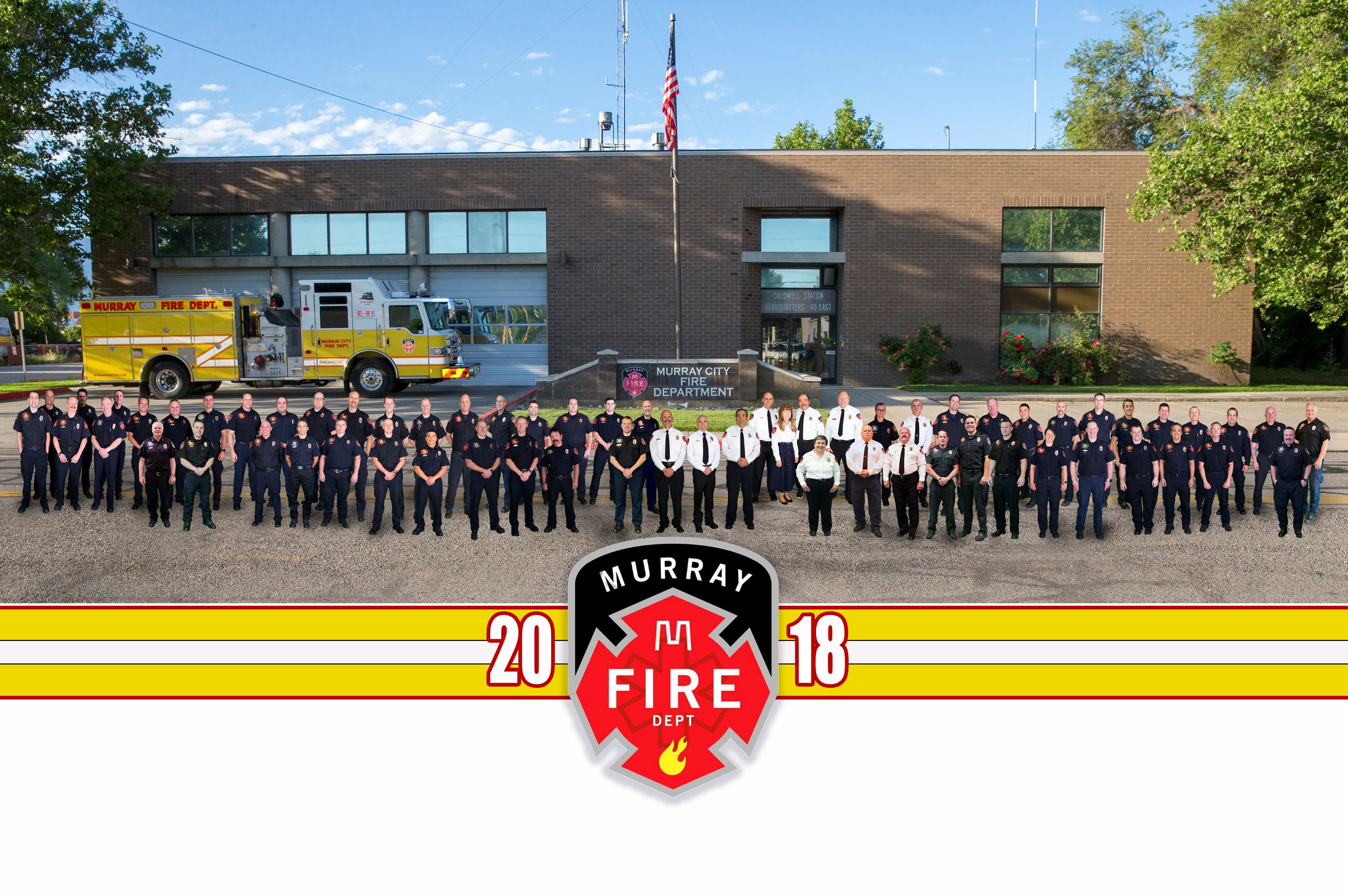 Fire Department Employees Standing in Front of the Fire Station